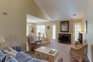 a living room with a blue couch and a fireplace at Evian 285 in Hilton Head Island