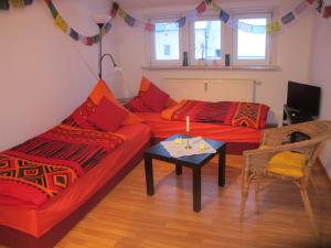 a living room with two red couches and a table at Sapana in Pockau