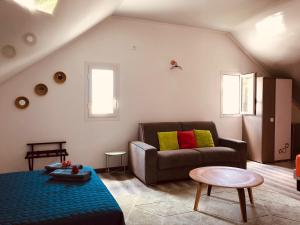 a living room with a couch and a table at La Villa Maé in Saint-Pierre