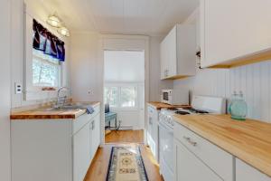 a kitchen with white cabinets and a sink at Toddy Pond Jack in Orland