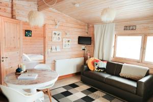 a living room with a couch and a table at Kaldá Lyngholt in Egilsstaðir