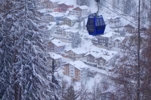 a town covered in snow with a ski lift at Alkira in Sankt Anton am Arlberg