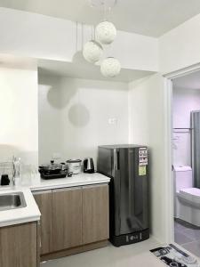 a kitchen with a stainless steel refrigerator and a sink at Stunning Tropical resort condo in Mactan