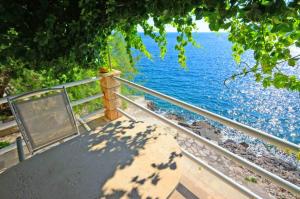 a view of a body of water with a table at Apartments Ranko in Zavalatica