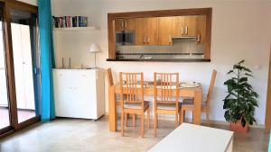 a kitchen with a table and chairs and a refrigerator at LA FLORIDA in San Luis de Sabinillas