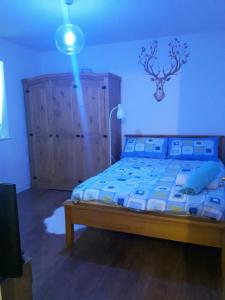 a bedroom with a large bed with a blue at Lavi's house-East Milton Keynes in Milton Keynes