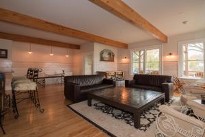 a living room with leather furniture and a table at Hotel Broad Ripple in Indianapolis