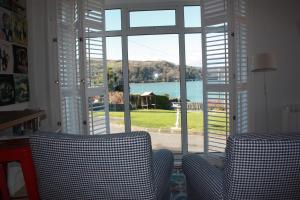 a room with a window with a view of the water at Shearwater Studio Apt in Union Hall