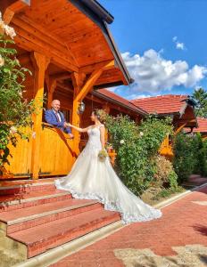 a bride and groom in front of a building at Eko Apartmani in Bački Petrovac