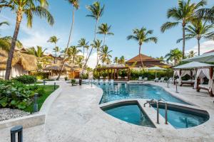 a pool at a resort with palm trees at Be Live Collection Punta Cana - All Inclusive in Punta Cana