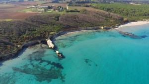 an aerial view of a beach and the ocean at Masseria Mongiò dell'Elefante in Otranto
