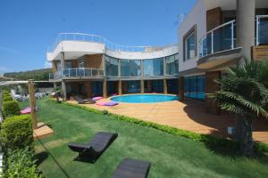 a large house with a swimming pool in the yard at Alaçatı Çınar Boutique Hotel in Alaçatı
