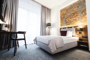 Postel nebo postele na pokoji v ubytování Best Western Hotel Mariacki Katowice