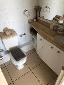 a bathroom with a toilet and a sink at Mar Serena vista al Mar in La Serena