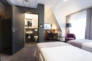 Postel nebo postele na pokoji v ubytování Best Western Hotel Mariacki Katowice