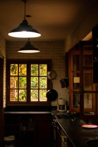 a kitchen with two lights and a window at Posada juan Ignacio in Rosario