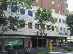 a building on a city street with motorcycles parked in front at Luxury Cheope in Piacenza