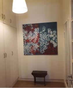 a room with a painting on the wall and a table at Flat in historic neighbourhood in Lisbon