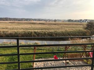 a view of a field from a fence at Apartament koloru morza - Szmaragd in Łeba