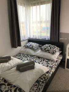 two beds sitting next to each other in a room at Apartament koloru morza - Turkus in Łeba