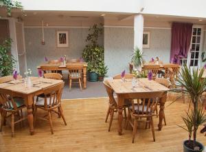 a dining room with wooden tables and chairs at The Commercial in St. Just