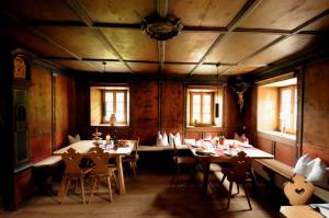 a room filled with furniture and a table at Steinwandterhof in Braies