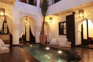 a lobby with a swimming pool in a building at Riad Dar Bahi in Marrakesh