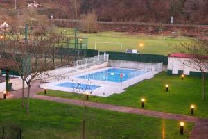 a large swimming pool in a park with a field at Apartamento Oronoz in Oronoz-Mugaire