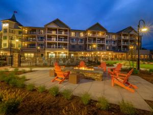 a hotel with orange chairs and a fire pit at Chautauqua Harbor Hotel - Jamestown in Celoron