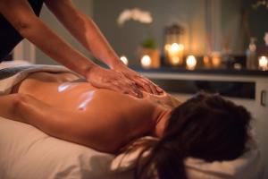 a woman getting a back massage in a bed at Southbridge Napa Valley in St. Helena