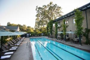 a large swimming pool with chairs and a building at Southbridge Napa Valley in St. Helena