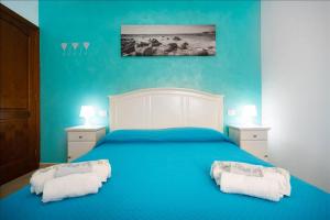 a blue bedroom with a large bed with two pillows at Canary House Gold in Vecindario