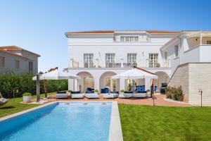a villa with a swimming pool in front of a house at Villa Hermitage in Vabriga