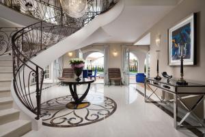 a staircase in a home with a wrought iron railing at Villa Hermitage in Vabriga