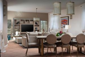 a dining room and living room with a table and chairs at Villa Giulia in Vabriga