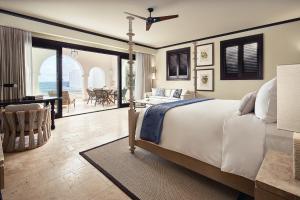 a bedroom with a bed and a view of the ocean at Cap Juluca, A Belmond Hotel, Anguilla in West End Village