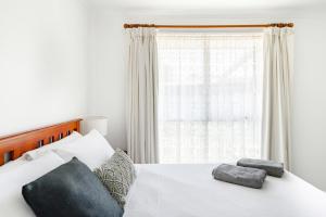 Un dormitorio con una cama blanca con una ventana. en Cyprus Place, en Melton 22 fotos más