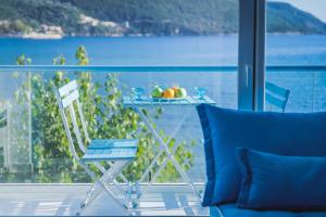 a table and chairs on a balcony with a view of the water at Seafront Luxury residence with amazing view in Vasiliki