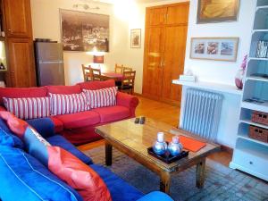 a living room with a red couch and a coffee table at Ski Station Apartments in Arinsal