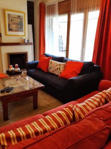 a living room with a couch and a coffee table at Ski Station Apartments in Arinsal