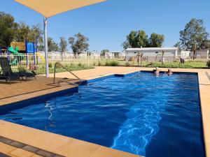 a swimming pool with a pool table and chairs at Waikerie Holiday Park in Waikerie
