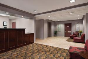 a lobby with a waiting area with chairs and a desk at Hawthorn Suites by Wyndham Lancaster in Lancaster