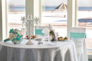 a table with a white table cloth and a bottle of wine at Aqua Blue Hotel in Narragansett