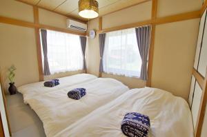 two beds in a small room with two pillows on them at Villent Kujukuri Arrow in Kujukuri +57 photos