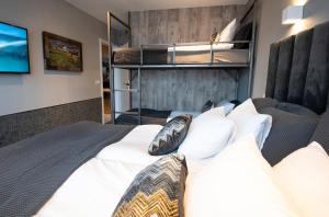 a bedroom with a bed with white sheets and pillows at B14 Apartments & Rooms in Reykjavík