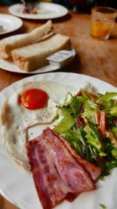 a plate of food with an egg and a salad at Beach Side Inn Shirahama in Shimoda