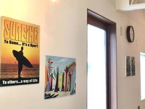 a room with two posters on the wall at Beach Side Inn Shirahama in Shimoda
