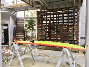 a surfboard on a stand in a garage at Beach Side Inn Shirahama in Shimoda