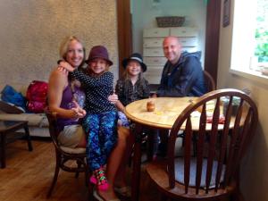 a family posing for a picture at a table at Beach Side Inn Shirahama in Shimoda