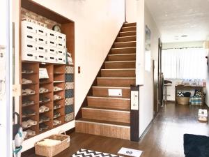 a staircase in a room with a stair case at Beach Side Inn Shirahama in Shimoda